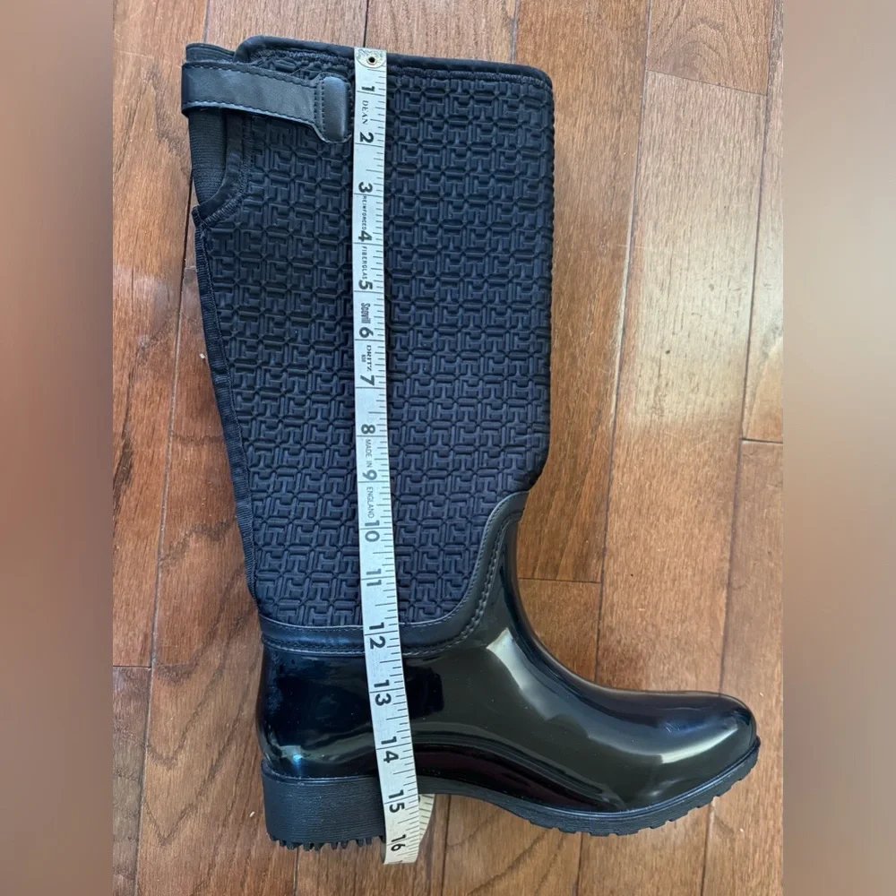 Tommy Hilfiger Black Boots. Gold accent hardware, logo embossed fabric.